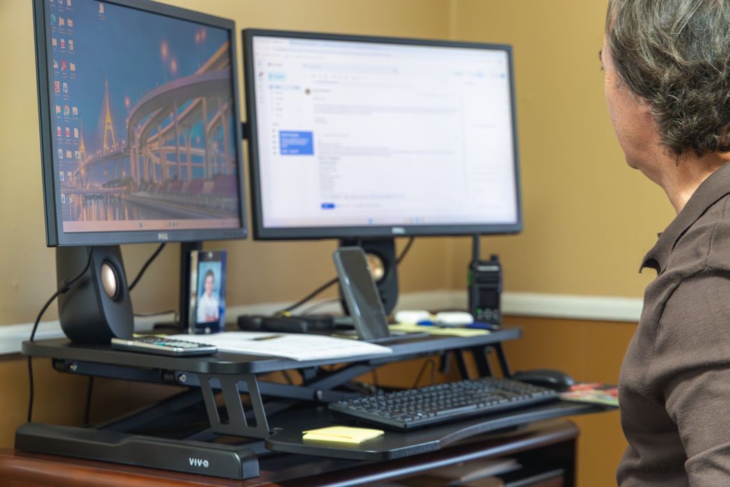 Marketing workstation with property listings on two monitors