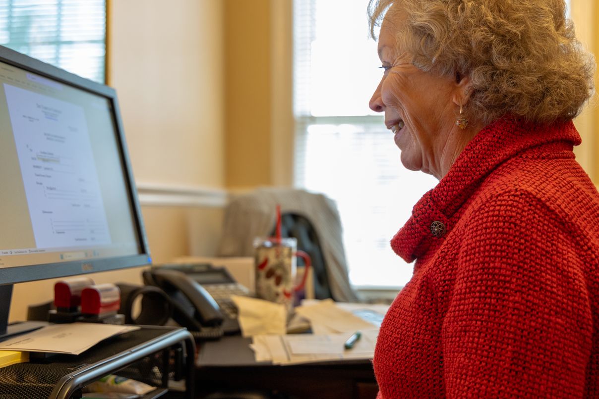 Temples Company team member working at her desk
